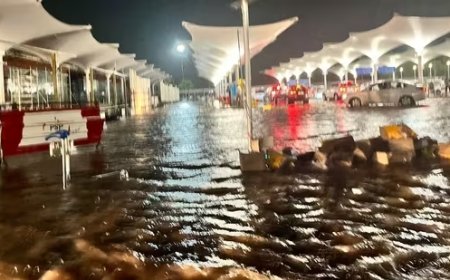 Ahmedabad airport submerged in heavy rain; passengers wading through knee-deep water. Viral videos capture the scene.